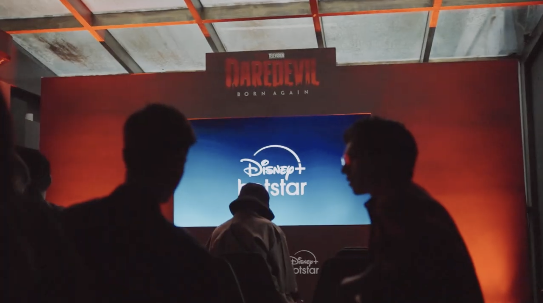 Fans silhouetted in front of the Daredevil: Born Again and Disney+ Hotstar stage