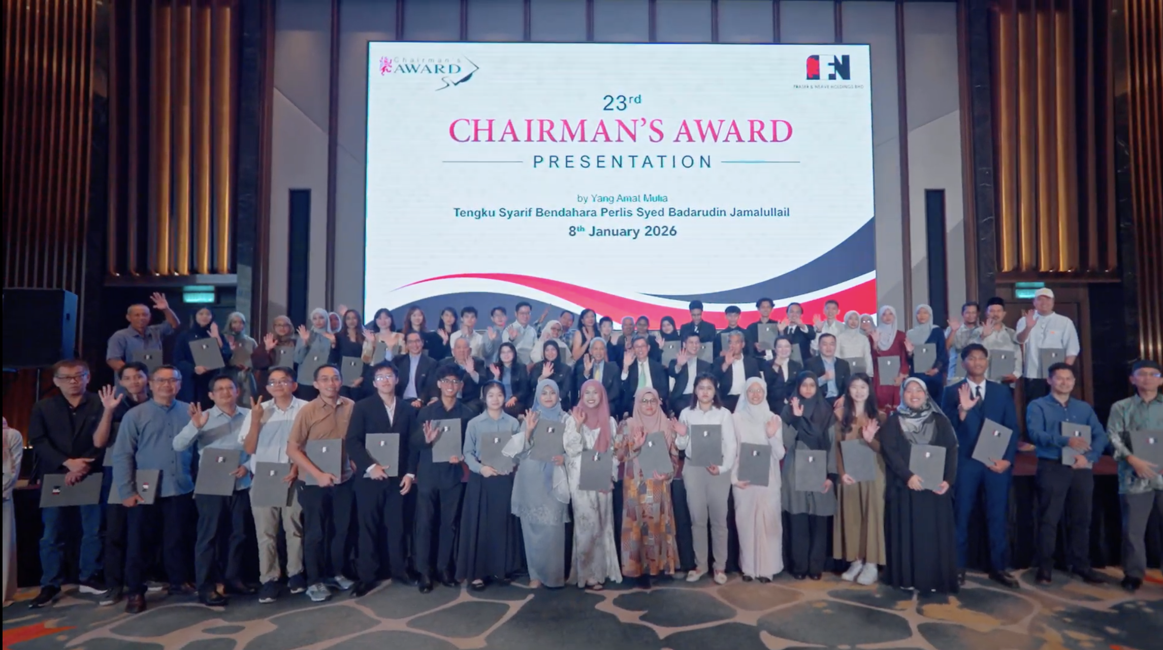 Award recipients waving on stage beneath the 23rd Chairman's Award screen