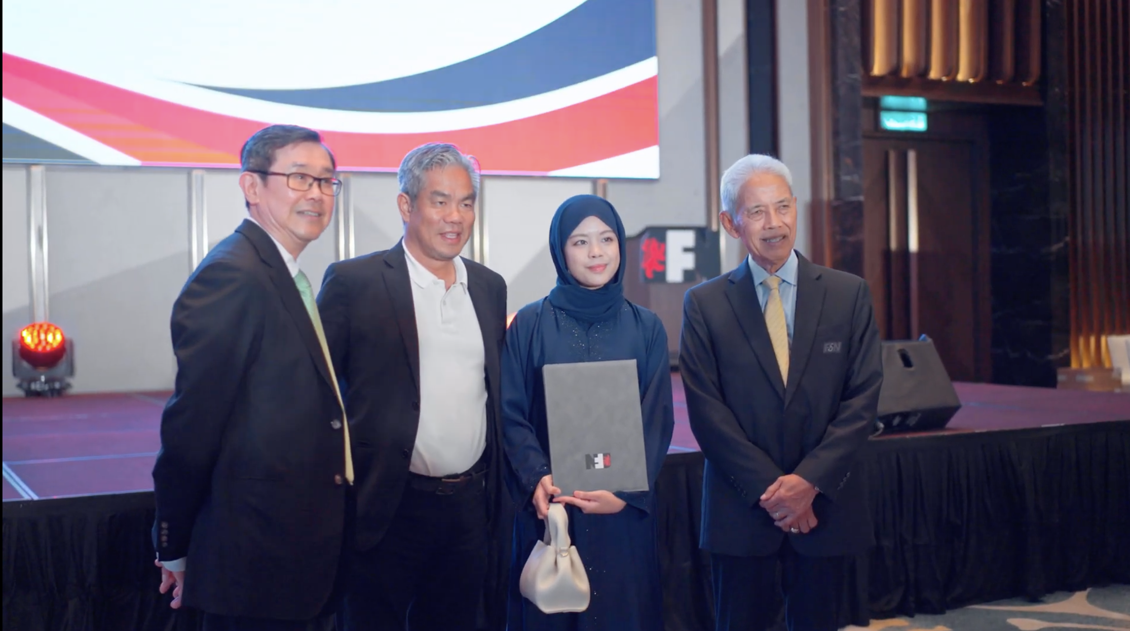 Award recipient posing with F&N leadership