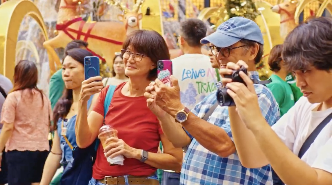Onlookers filming the performance on their phones and cameras