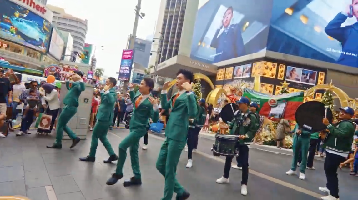 Squad dancing down Bukit Bintang with the marching band