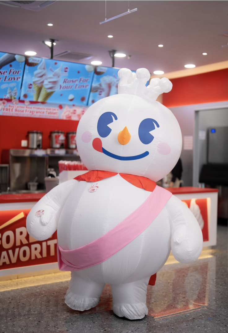 Snow King mascot in front of the MIXUE counter