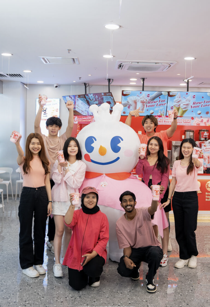 Group raising MIXUE drinks with the Snow King mascot